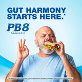 Older man happily eats a sandwich and makes an OK gesture, with visible PB8 Probiotic text in the background.